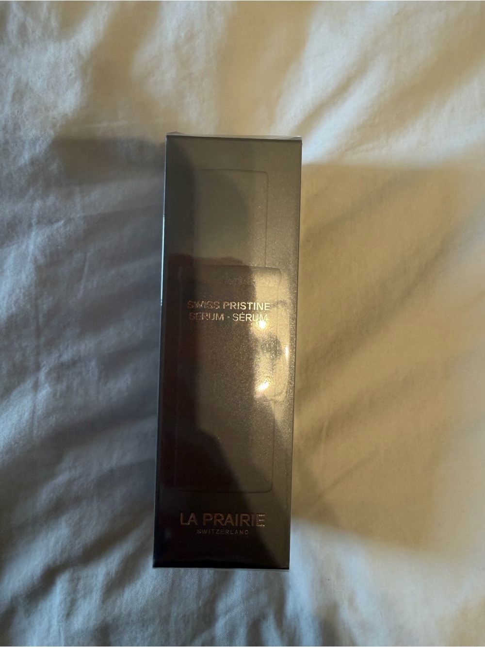 La Prairie Serum in Glossy Black and Gold Accents